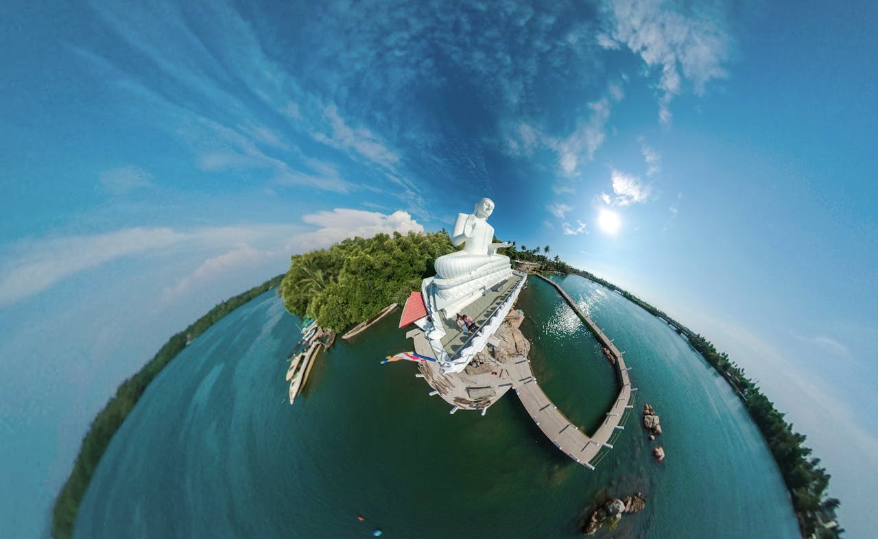 A stunning 360-degree aerial view of a Buddha statue by a tranquil lake in Sri Lanka.