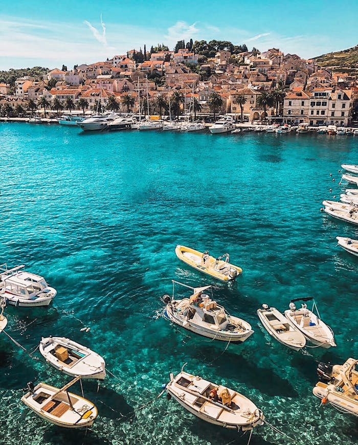 Crafting Captivating Headlines: Your awesome post title goes here Boats in the vibrant blue waters of Hvar, Croatia, showcasing a charming coastal town under sunny skies.